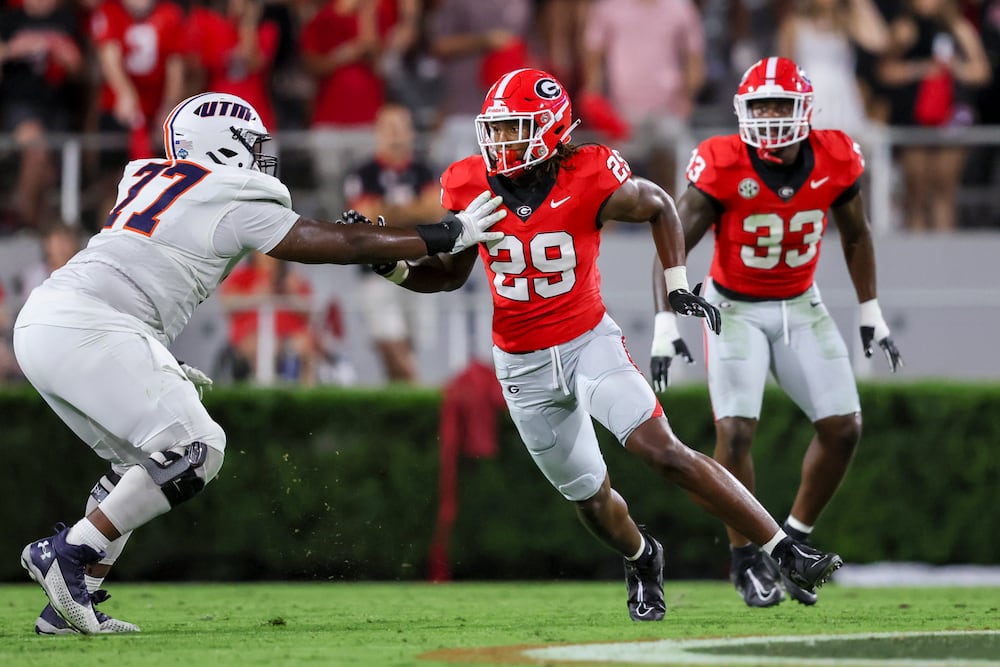 Georgia linebacker Gabe Harris (center) goes against UT Martin offensive lineman Lamar Morgan during their game at Sanford Stadium, Saturday, Sept. 2, 2023, in Athens, Ga. (Jason Getz/AJC)