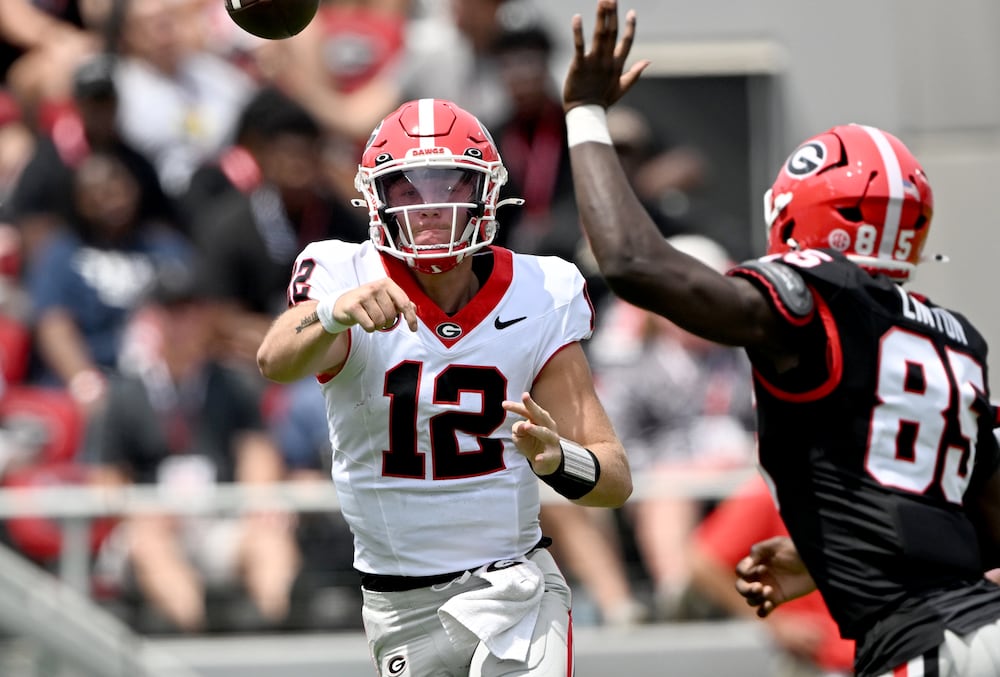 Georgia quarterback Ryan Puglisi (left) gets off a pass during the G-Day spring football game at Sanford Stadium on Saturday, April 18, 2026, in Athens. (Hyosub Shin/AJC)