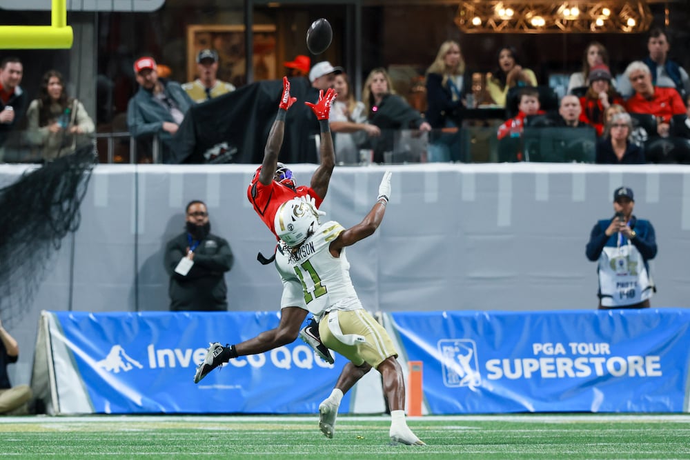 Georgia defensive back Ellis Robinson IV (left) intercepts a pass intended for Georgia Tech wide receiver Dean Patterson on Friday, Nov. 28, 2025, at Mercedes-Benz Stadium in Atlanta. (Jason Getz/AJC)