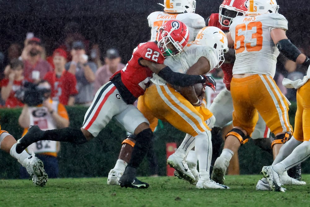 Volunteers quarterback Hendon Hooker (center) is sacked by Bulldogs defensive back Javon Bullard at Sanford Stadium on Saturday, Nov. 5, 2022, in Athens. (Jason Getz/AJC)