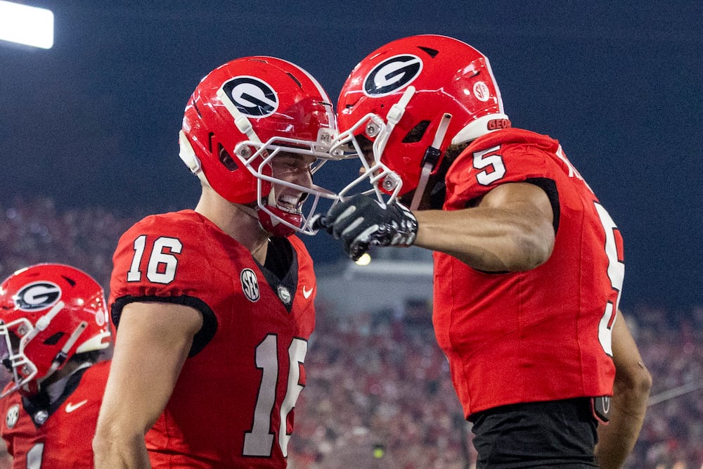 Georgia wide receiver London Humphreys (left) celebrates with wide receiver Noah Thomas after scoring a 30-yard touchdown reception against Texas at Sanford Stadium on Saturday, Nov. 15, 2025, in Athens. (Jason Getz/AJC)