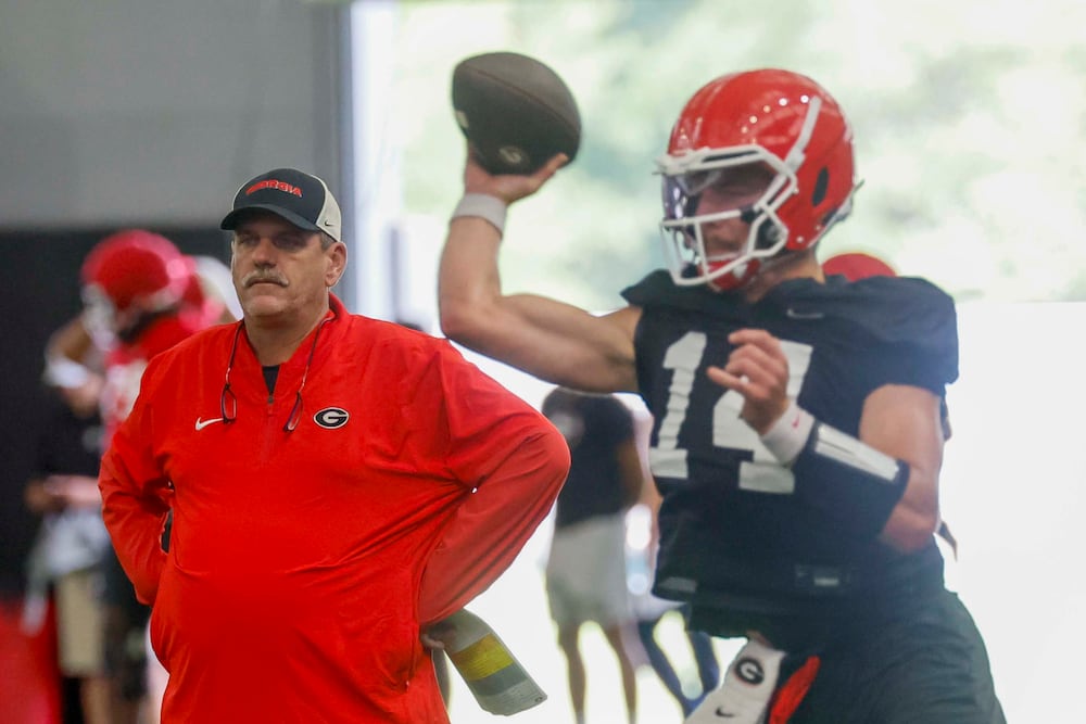 Georgia offensive coordinator Mike Bobo (left) watches quarterback Gunner Stockton throw a pass during their first fall football practice on Wednesday, Aug. 5, 2026, in Athens. (Miguel Martinez/AJC)
