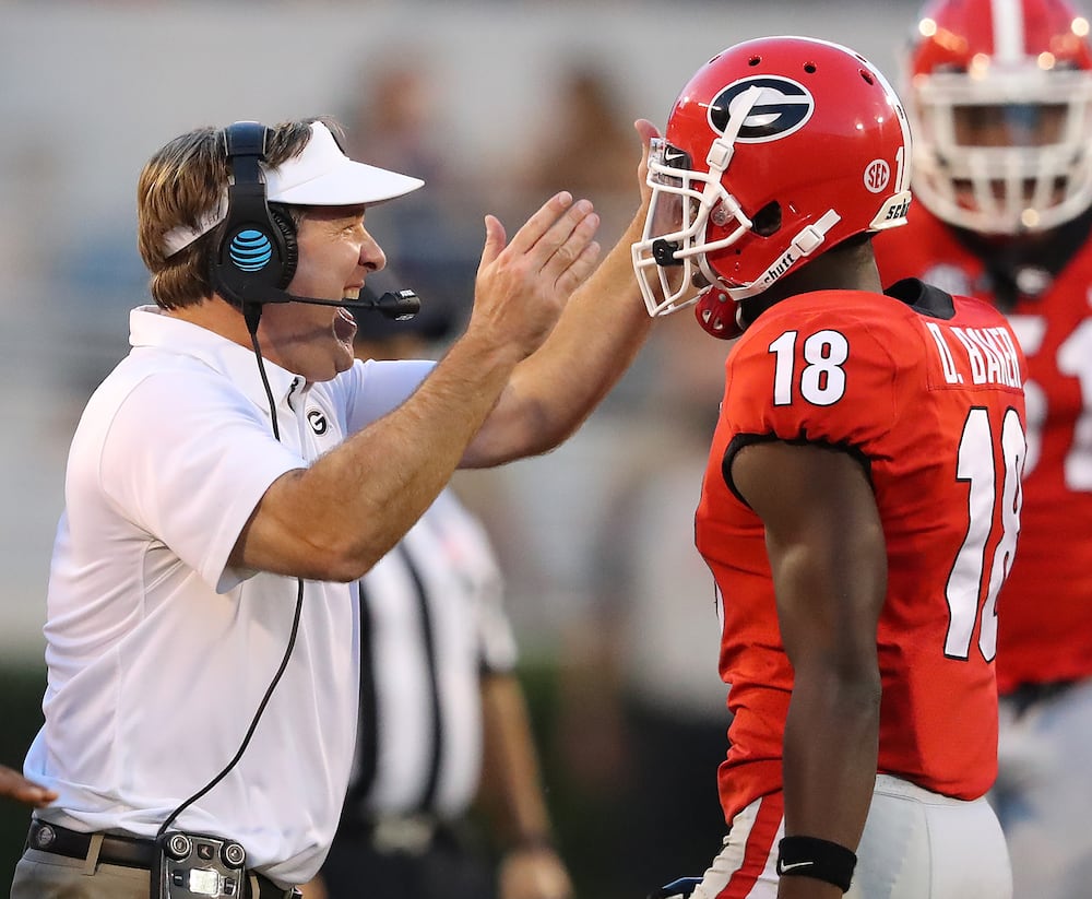 Georgia coach Kirby Smart gives defensive back Deandre Baker a double pat on the helmet after he stopped South Carolina on a fourth down play to take over on downs during the fourth quarter in a NCAA college football game on Saturday, November 4, 2017, in Athens. (Curtis Compton/AJC file photo)