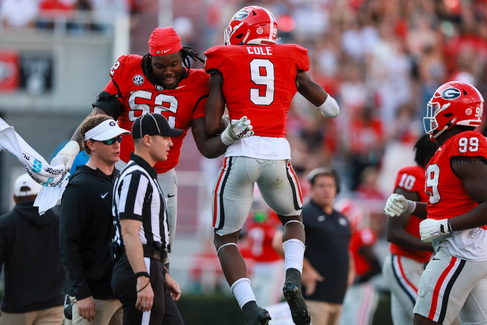 Georgia linebacker Chris Cole (right) celebrates a sack with defensive lineman Christen Miller during their game against Charlotte at Sanford Stadium on Friday, Nov. 22, 2025, in Athens. (Jason Getz/AJC)
