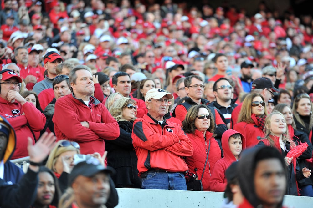 November 29, 2014 Athens - Georgia Bulldogs fans react during the overtime play at Sanford Stadium in Athens on Saturday, November 29, 2014. In the 109th playing of the Tech-Georgia game, the No. 16 Yellow Jackets ended the No. 9 Bulldogs' five-game winning streak in the series with a 30-24 overtime win at Sanford Stadium Saturday afternoon. HYOSUB SHIN / HSHIN@AJC.COM