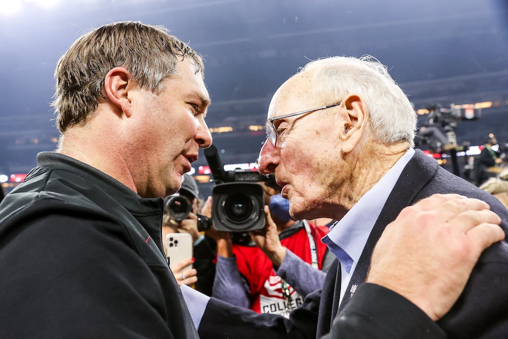 Coach Kirby Smart (left) speaks with Vince Dooley after Georgias national championship win over Alabama. (Tony Walsh/UGA 2022)