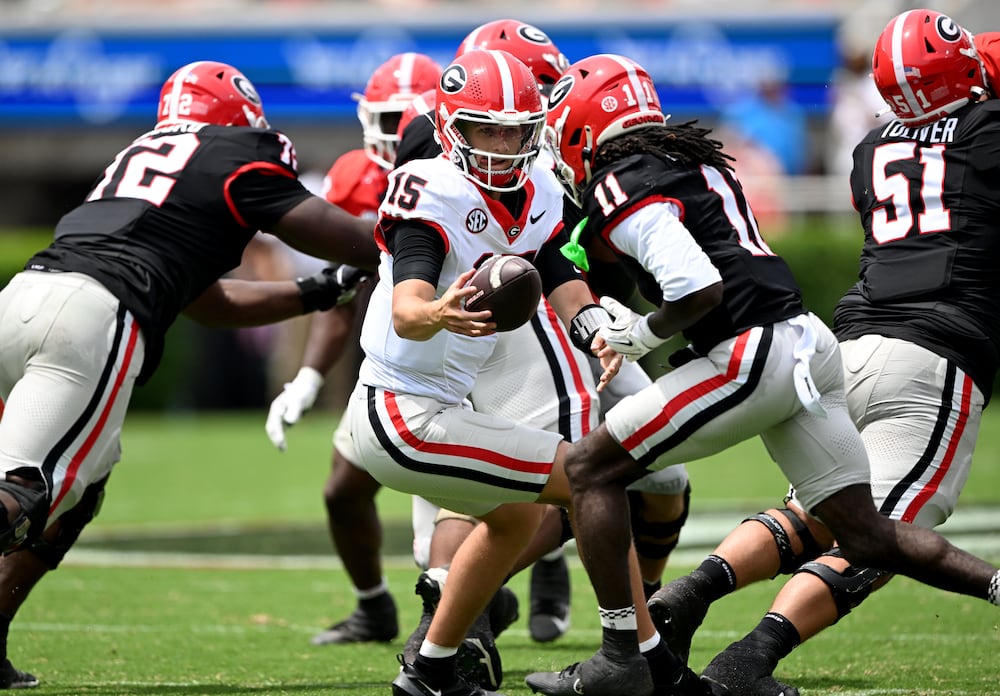 Georgia quarterback Ryan Montgomery (center) makes a handoff to wide receiver Jeremy Bell during the G-Day spring football game at Sanford Stadium on Saturday, April 18, 2026, in Athens. (Hyosub Shin/AJC)