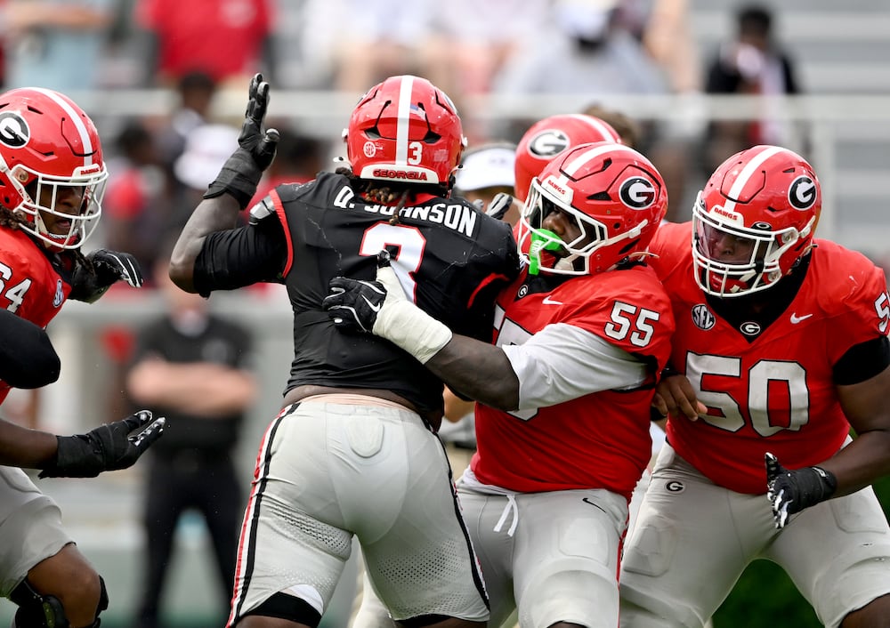 Georgia center Zykie Helton (second from right) blocks Quintavius Johnson (center) during the G-Day spring football game at Sanford Stadium on Saturday, April 18, 2026, in Athens. (Hyosub Shin/AJC)