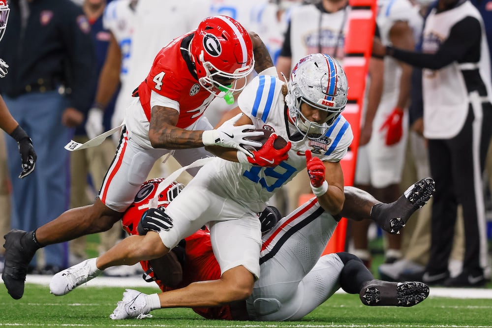 Georgia Bulldogs defensive back KJ Bolden (left) tackles Ole Miss Rebels wide receiver Cayden Lee during the Sugar Bowl at Caesars Superdome on Thursday, Jan. 1, 2026, in New Orleans. (Jason Getz/AJC)
