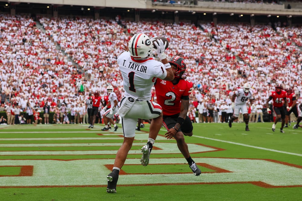 Georgia wide receiver Talyn Taylor (1) makes a 5-yard touchdown catch against Western Kentucky defensive back Tony Newsome Jr. (2) during the second quarter in their NCAA football game at Sanford Stadium, Saturday, Sept. 12, 2026, in Athens, Ga. Georgia won 70-20. (Jason Getz/AJC)