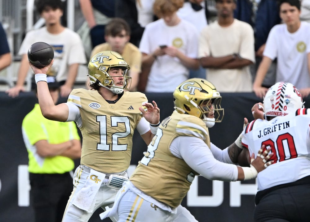 Georgia Tech quarterback Aaron Philo (left) gets off a pass during the second half against Gardner-Webb in November in Atlanta. (Hyosub Shin/AJC)