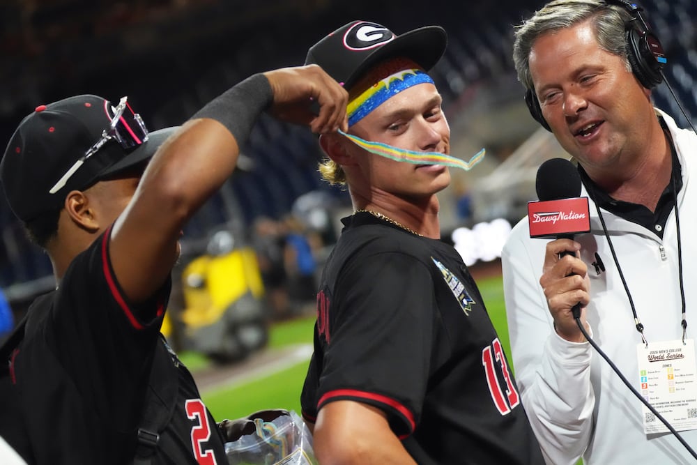 DawgNation host Brandon Adams interviews Georgia baseball player Scott Newman as Ryan Black drapes Sour Power candy on his shoulder. (Cody Chaffins/DawgNation)