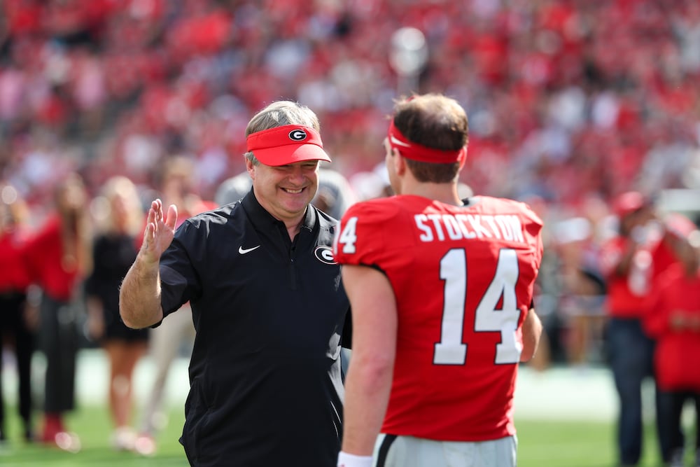 Georgia coach Kirby Smart (left) greets quarterback Gunner Stockton for Senior Day recognition before their game against Charlotte at Sanford Stadium on Saturday, Nov. 22, 2025, in Athens. (Arvin Temkar/AJC)