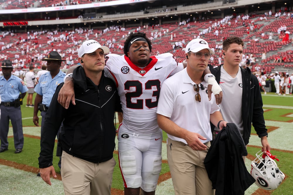 Georgia safety Tyriq Green (center) gets helped off of the field after the Bulldogs' 70-20 win over Western Kentucky on Saturday, Sept. 12, 2026, at Sanford Stadium in Athens. (Jason Getz/AJC)