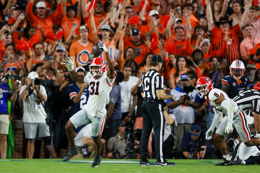 Georgia defensive back Kyron Jones (left) reacts after recovering a fumble by Auburn quarterback Jackson Arnold (not pictured) at Jordan-Hare Stadium on Saturday, Oct. 11, 2025, in Auburn, Ala. (Jason Getz/AJC)