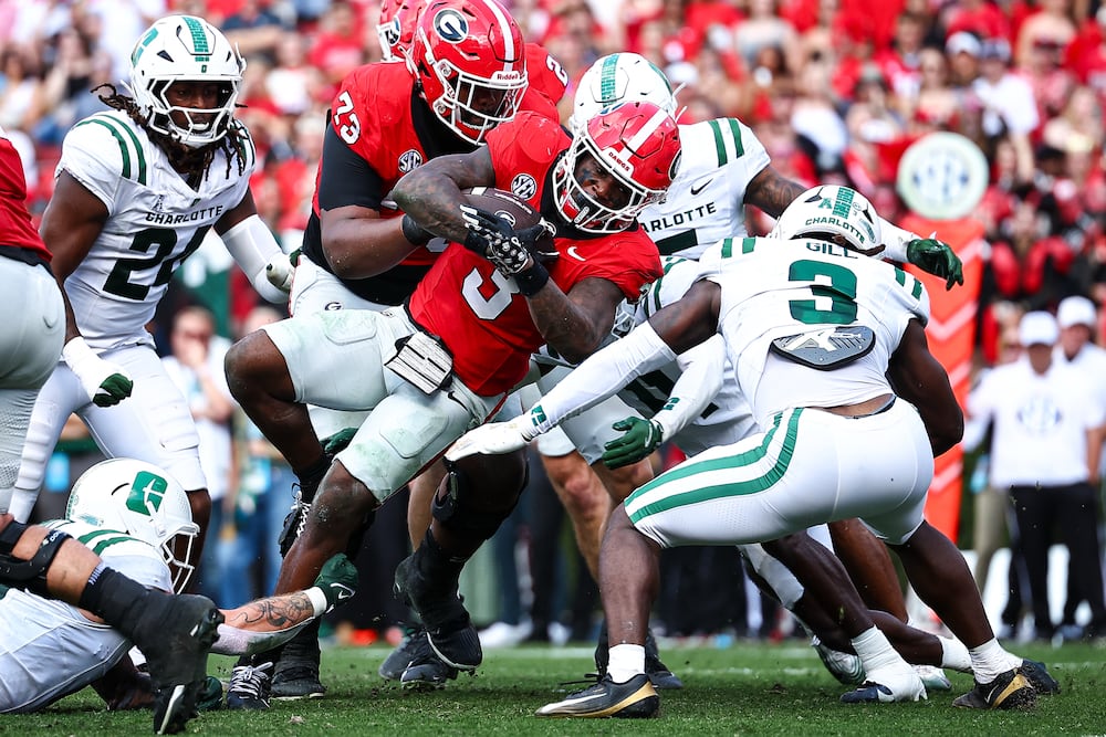 FILE - Georgia running back Nate Frazier, center, runs with the ball before scoring a touchdown during the first half of an NCAA college football game against Charlotte, Nov. 22, 2025, in Athens, Ga. (AP Photo/Colin Hubbard, File)
