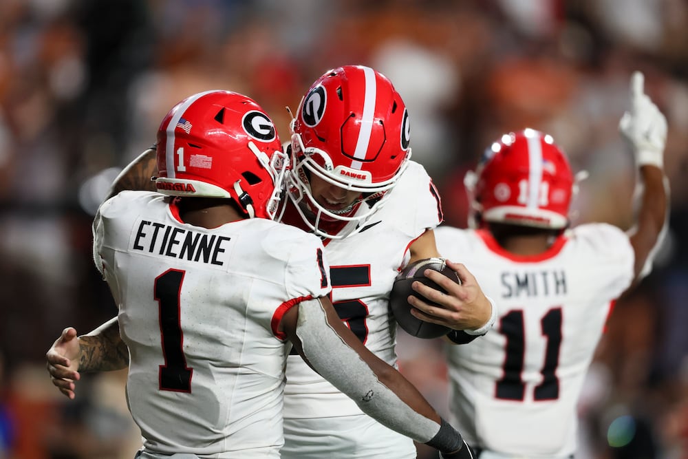 Georgia quarterback Carson Beck (right) and running back Trevor Etienne celebrate as time expires during their game against Texas at Darrell K Royal-Texas Memorial Stadium on Saturday, Oct. 19, 2024, in Austin, Texas. (Jason Getz/AJC)
