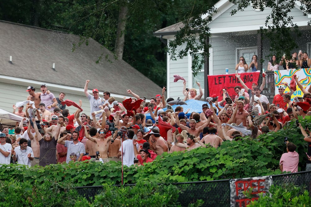 Georgia Bulldog fans celebrate at Kudzu Hill after a home run by Georgia Bulldogs catcher Daniel Jackson (3) in the tenth inning of game 2 of the NCAA Super Regional at Foley Field on Sunday, June 7, 2026, in Athens. Miguel Martinez/AJC)