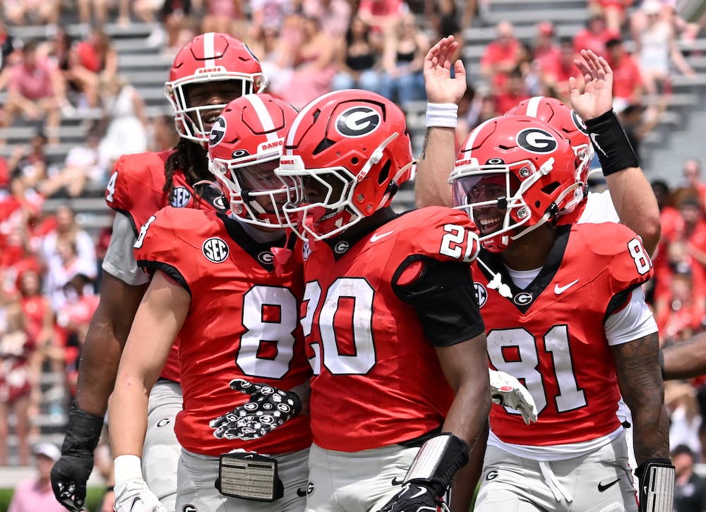 Georgia running back Dwight Phillips Jr. (center) celebrates with teammates during the G-Day spring football game in April in Athens. (Hyosub Shin/AJC)