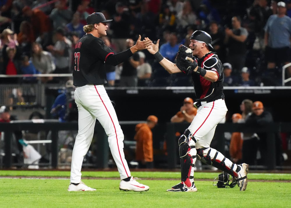 Georgia pitcher Joey Volchko (left) celebrates with catcher Daniel Jackson following a complete game win against Texas at the College World Series on Sunday, June 14, 2026, in Omaha, Nebraska. (Cody Chaffins/AJC)