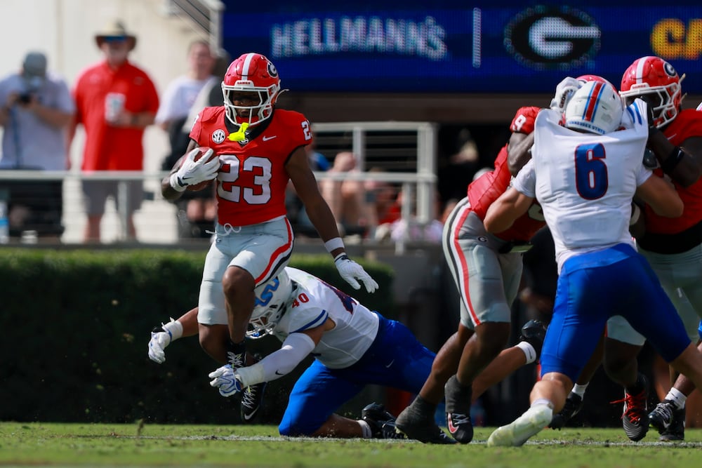 Georgia safety Tyriq Green (left) tries to avoid the tackle of Tennessee State's Richard Garrett (bottom) on a punt return Saturday, Sept. 5, 2026, at Sanford Stadium in Athens. Georgia won 63-3. (Jason Getz/AJC)