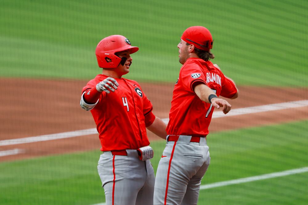 Georgia's Michael O'Shaughnessy (left) celebrates his two-run home run with Jack Arcamone during the first inning against Georgia Tech at Truist Park on Tuesday, April 21, 2026, in Atlanta. (Jason Getz/AJC)