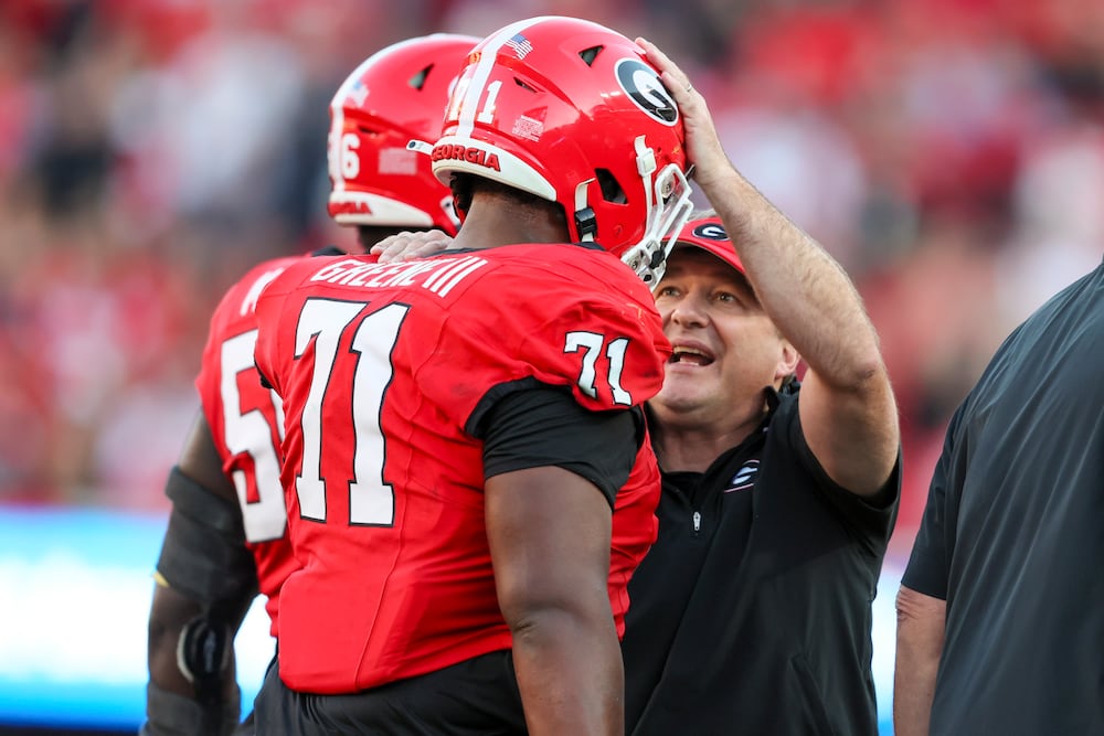 Georgia head coach Kirby Smart speaks with offensive lineman Earnest Greene III after a touchdown against Missouri at Sanford Stadium on Saturday, Nov. 4, 2023, in Athens. (Jason Getz/AJC)
