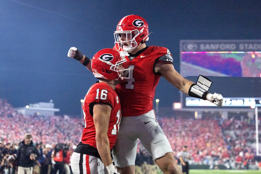 Georgia wide receiver London Humphreys (16) celebrates after scoring a 30-yard touchdown reception with Georgia tight end Oscar Delp (4) during the fourth quarter against Texas in their NCAA football game at Sanford Stadium, Saturday, Nov. 15, 2025, in Athens, Ga. Georgia won 35-10. (Jason Getz / AJC)