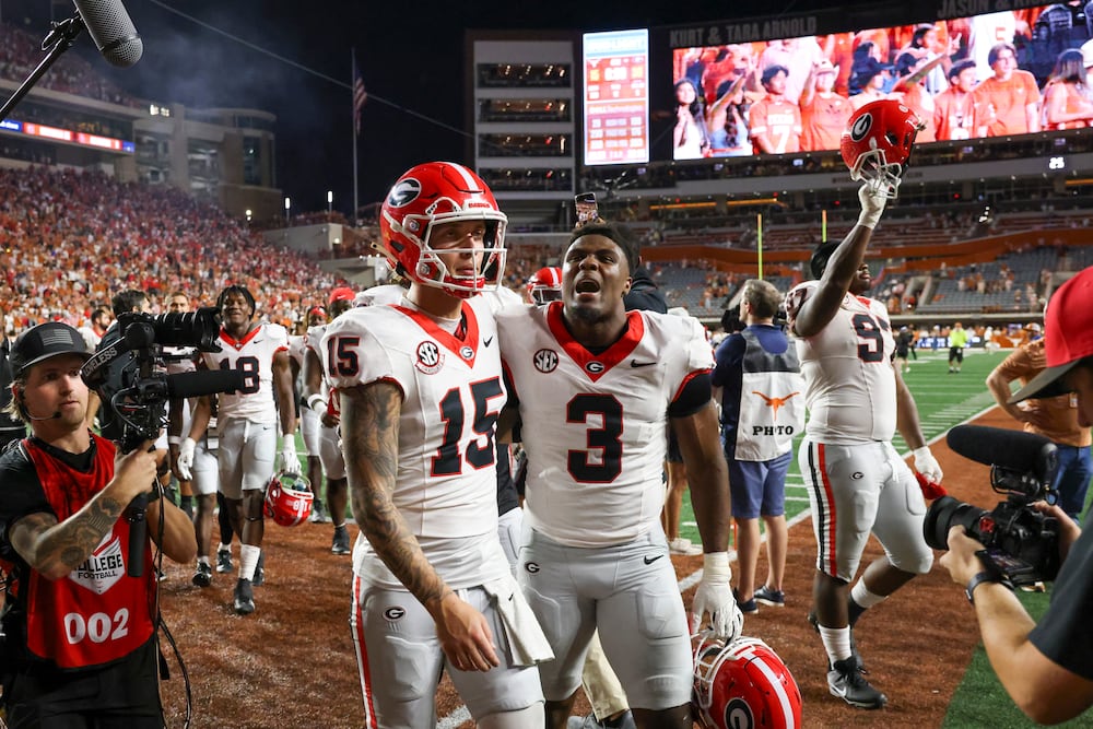 Georgia quarterback Carson Beck (left) and linebacker CJ Allen celebrate their 30-15 win over Texas at Darrell K Royal-Texas Memorial Stadium on Saturday, Oct. 19, 2024, in Austin, Texas. (Jason Getz/AJC)