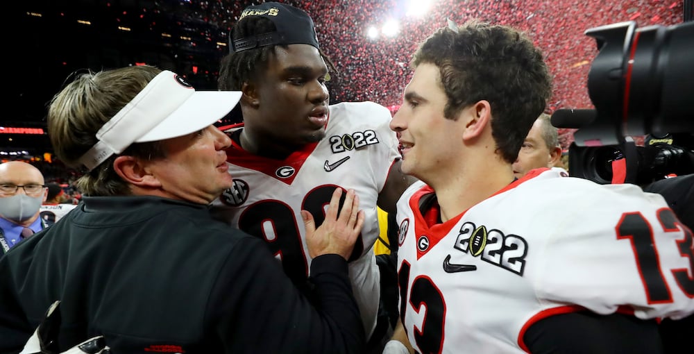 Georgia coach Kirby Smart (left) celebrates with defensive lineman Jordan Davis (center) and quarterback Stetson Bennett after Georgia's 33-18 win over Alabama in the 2022 College Football Playoff National Championship game. (Curtis Compton/AJC)