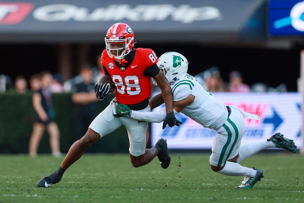 Georgia wide receiver Thomas Blackshear (left) runs after a catch against Charlotte at Sanford Stadium on Friday, Nov. 22, 2025, in Athens. (Jason Getz/AJC)