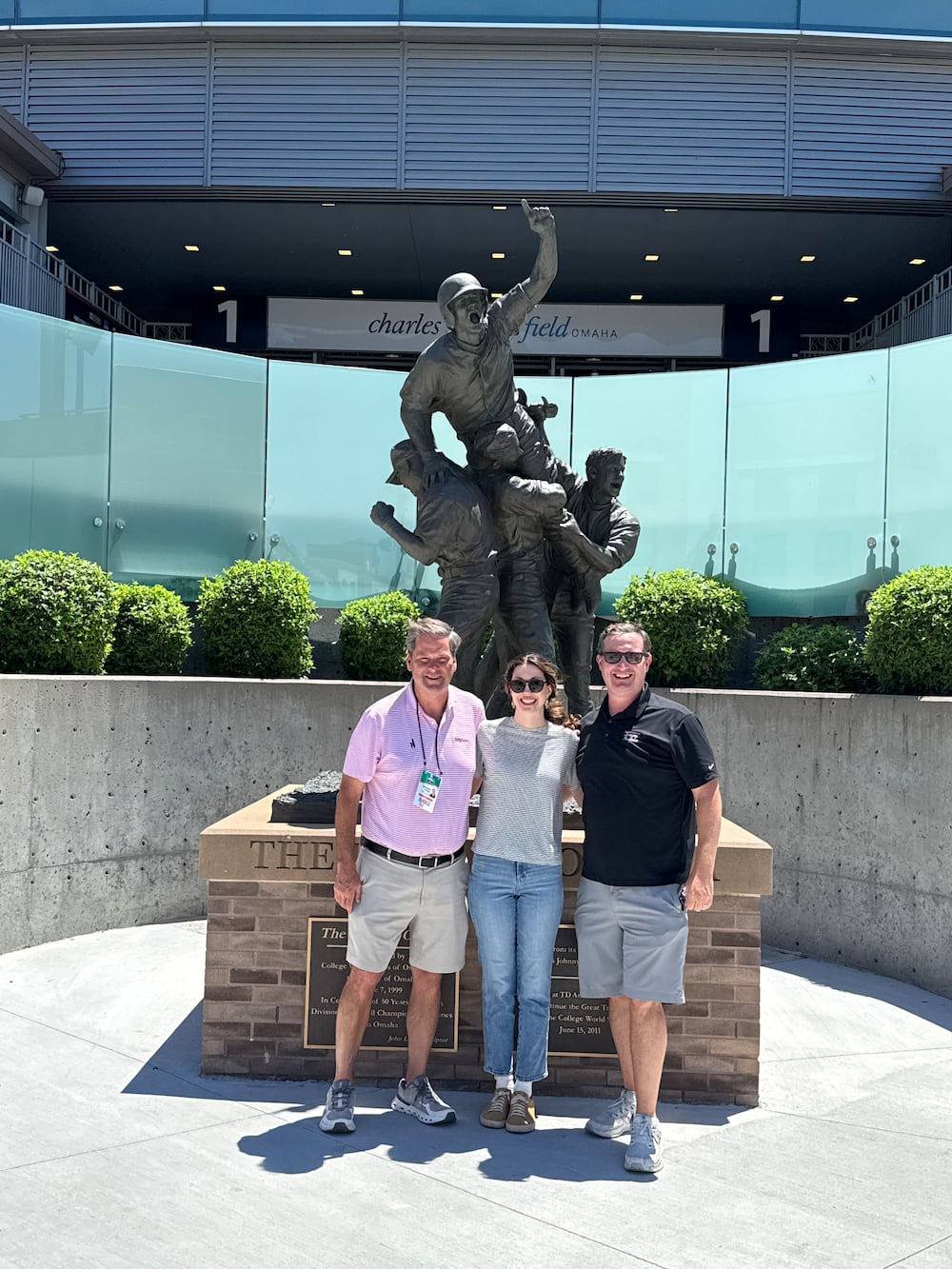 DawgNation's Brandon Adams, Sarah Spencer and Cody Chaffins in front of Charles Schwab Field in Omaha, Nebraska, ahead of the 2026 College World Series.