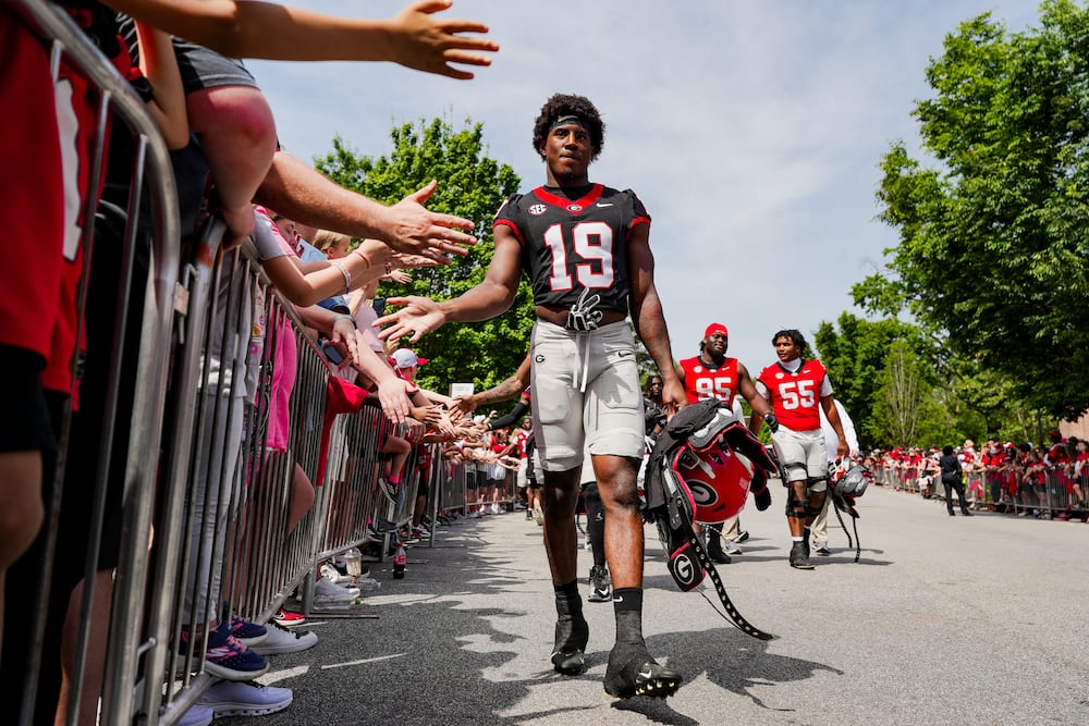 Georgia outside linebacker Justin Williams high-fives fans as he walks into the annual G-Day spring game at Sanford Stadium on Saturday, April 18, 2026, in Athens. (Tony Walsh/UGAAA)