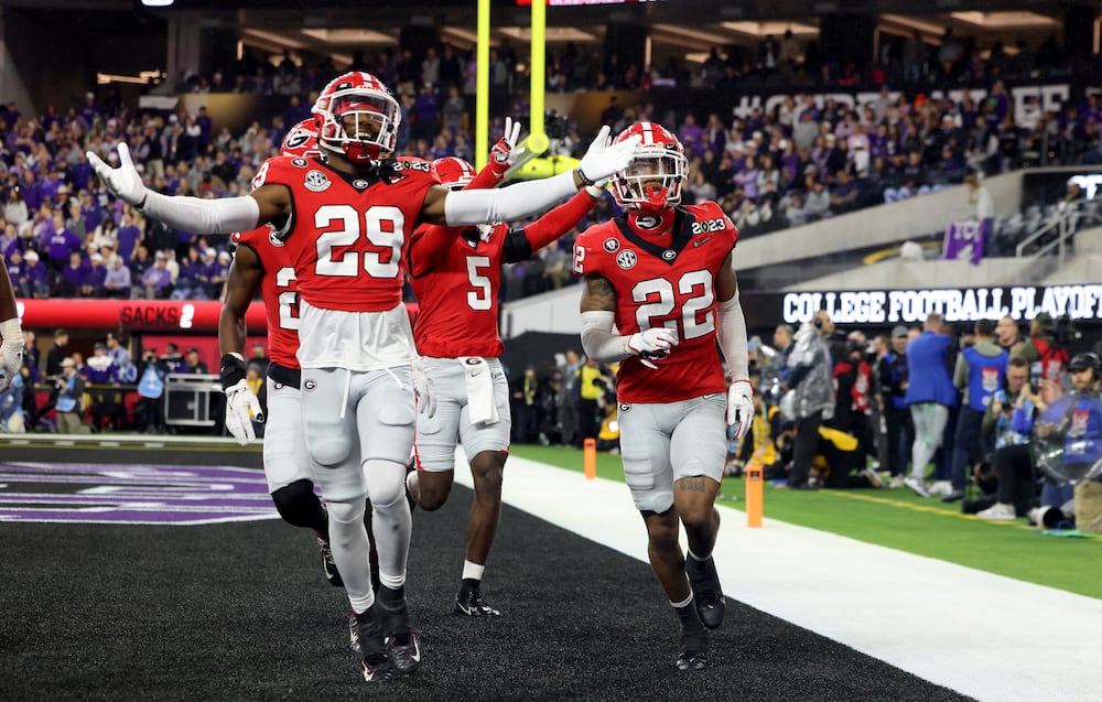Georgia Bulldogs defensive backs Christopher Smith (left) and Javon Bullard celebrate in the end zone during the College Football Playoff National Championship at SoFi Stadium in Los Angeles on Monday, Jan. 9, 2023. (Jason Getz/AJC)
