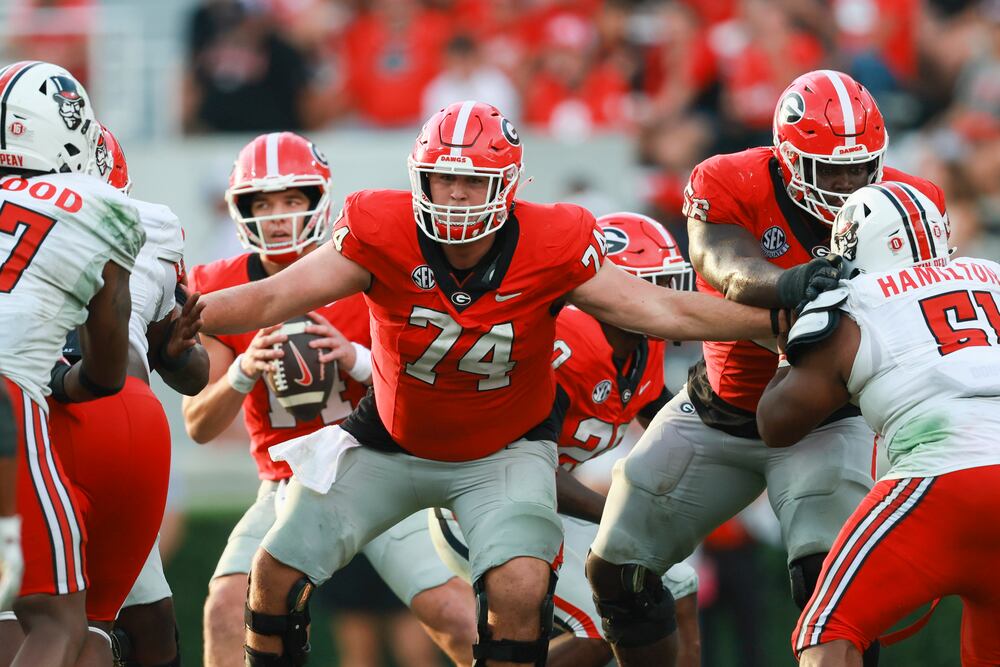 Georgia center Drew Bobo (74) and Georgia offensive lineman Micah Morris (56) block for Georgia quarterback Gunner Stockton (14) during their game against Austin Peay at Sanford Stadium, Saturday, September 6, 2025, in Athens, Ga. Georgia won 28-6. (Jason Getz / AJC)