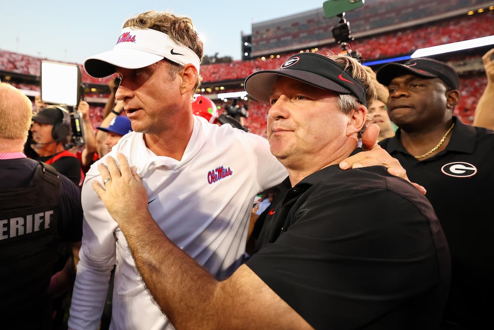 Then-Mississippi head coach Lane Kiffin (left) and Georgia head coach Kirby Smart meet at midfield after their game on Saturday, Oct. 18, 2025, in Athens. (Colin Hubbard/AP)
