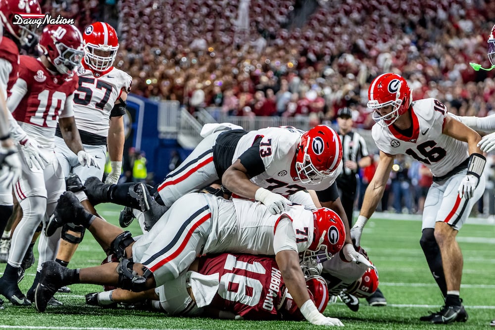 Georgia redshirt junior OT Earnest Greene III, shown on top of Alabama safety Bray Hubbard, was a key factor in the Bulldogs 28-7 victory during the SEC championship game on Saturday, Dec. 6, 2025, at Mercedes-Benz Stadium in Atlanta. (Jeff Sentell/DawgNation)