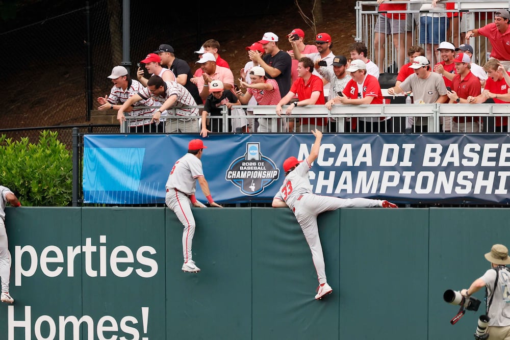 Georgia Bulldogs players celebrate in the outfield with fans after winning the NCAA Super Regional series by beating the Mississippi State Bulldogs 11-9 at Foley Field on Sunday, June 7, 2026, in Athens. Miguel Martinez/AJC)