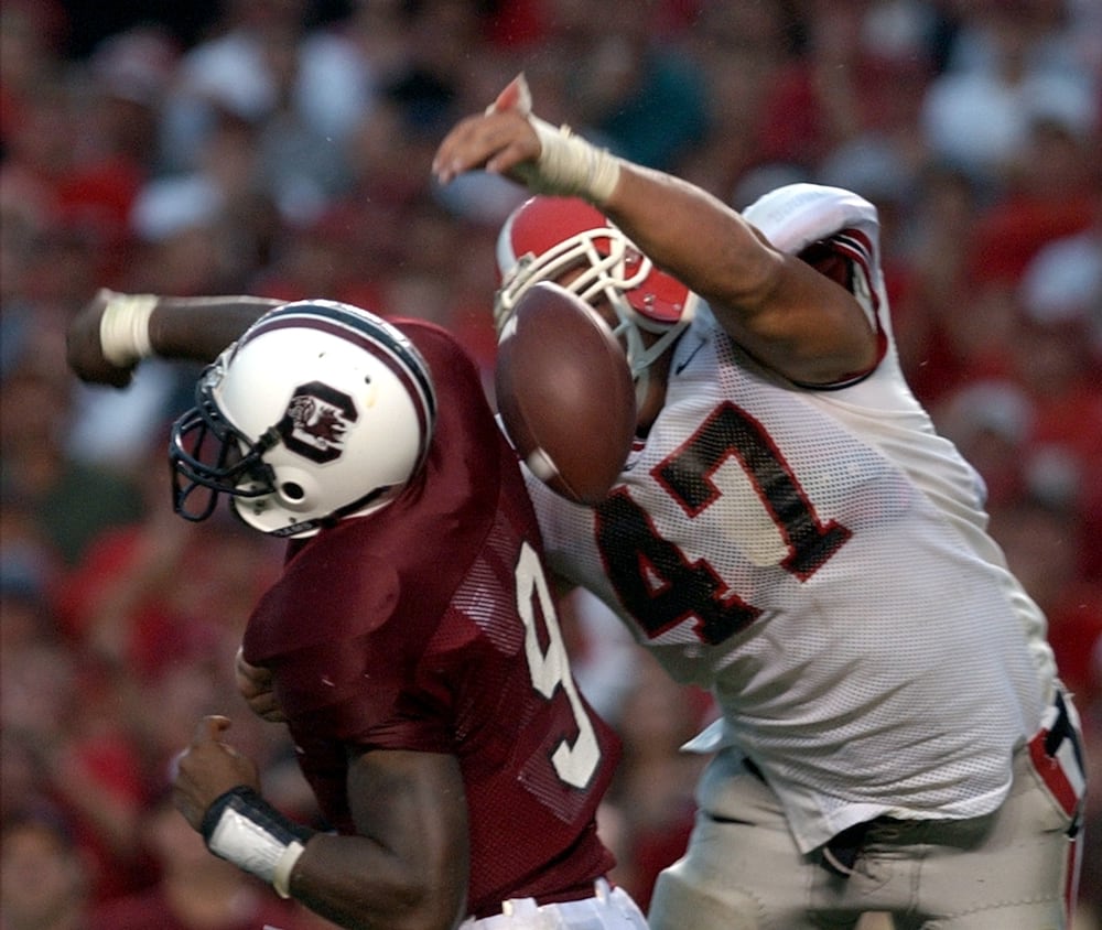 UGA's David Pollack (right) strips the ball from South Carolina quarterback Corey Jenkins in the end zone to score a memorable touchdown in 2002.