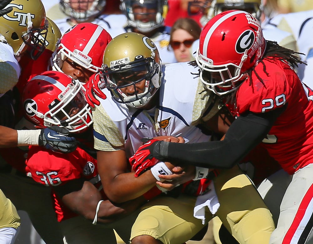 TECH SMOTHERED--112412 ATHENS Georgia defenders Shawn Williams (left) and Jarvis Jones (right) smother Georgia Tech quarterback Vad Lee on a fourth down attempt during 2nd half action in Athens on Saturday, Nov. 24, 2012. Georgia took over on downs after the stop. CURTIS COMPTON / CCOMPTON@AJC.COM