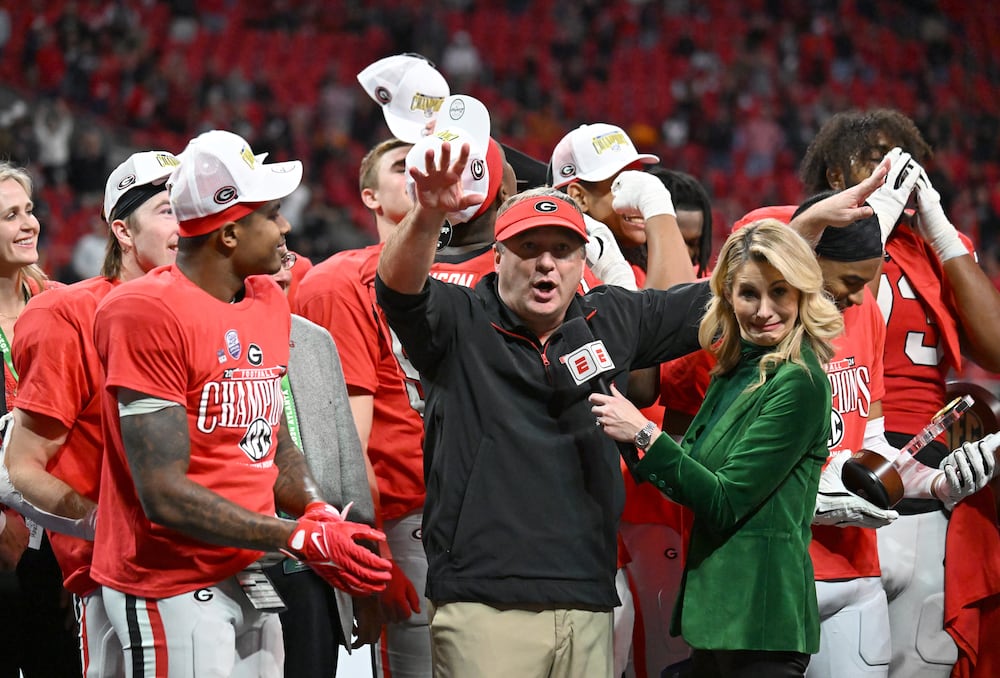 Georgia head coach Kirby Smart and players celebrate victory over Texas in overtime during the SEC Championship game Dec. 7, 2024, in Atlanta. (Hyosub Shin/AJC)