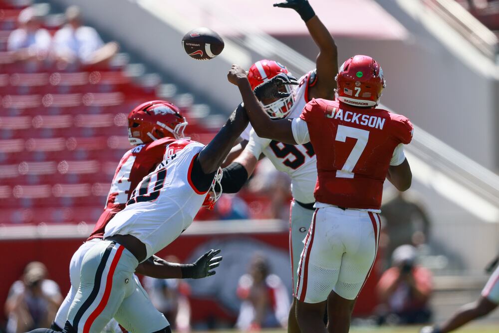 Georgia linebacker Zayden Walker (left) and defensive end Justin Greene break up a pass attempt by Arkansas quarterback KJ Jackson during the second half of Saturday's game. Georgia won 45-17. (Jason Getz/AJC)