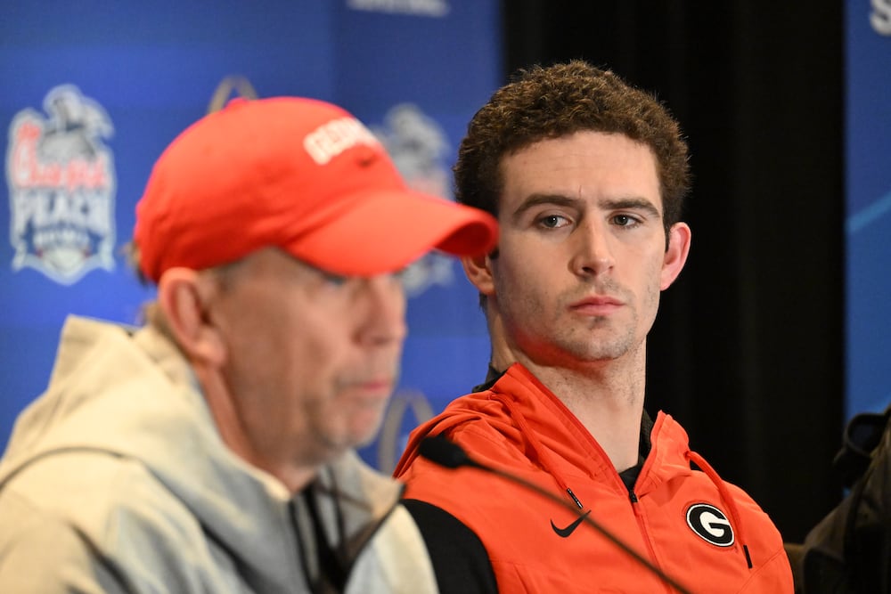 Georgia's then-offensive coordinator Todd Monken (left) speaks as quarterback Stetson Bennett looks on during a news conference on Wednesday, Dec. 28, 2022, in Atlanta.