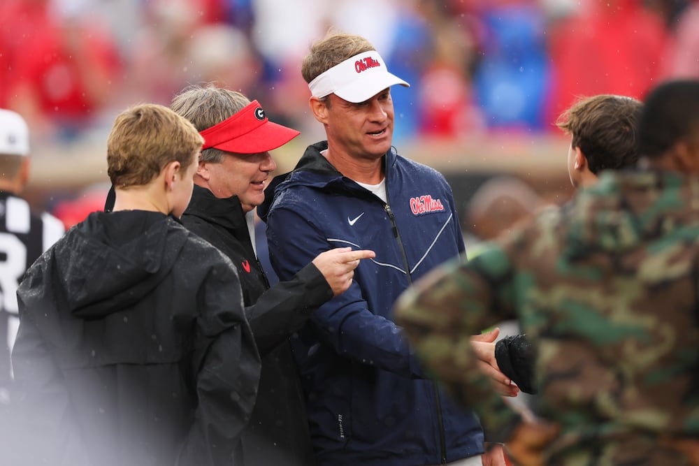 Georgia head coach Kirby Smart (left) introduces his sons to then-Mississippi head coach Lane Kiffin before their game at Vaught Hemingway Stadium on Saturday, Nov. 9, 2024, in Oxford, Ms. (Jason Getz/AJC)