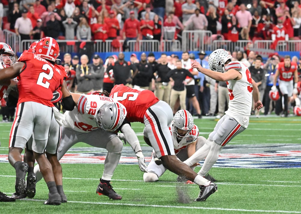 Ohio State place kicker Noah Ruggles (right) kicks the field goal, but misses, at the end of the fourth quarter during the Chick-fil-A Peach Bowl on Saturday, Dec. 31, 2022, in Atlanta. (Hyosub Shin/AJC)