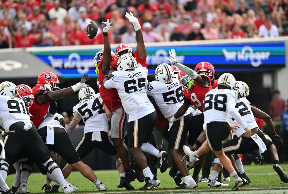Georgia defensive lineman Jordan Hall blocks a kick by Vanderbilt's Brock Taylor during the first half of Saturday's game in Athens. (Hyosub Shin/AJC)