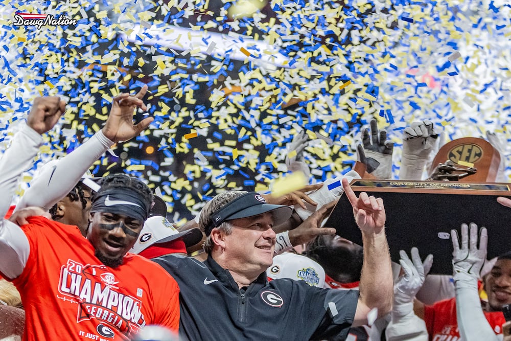 Georgia coach Kirby Smart (center) and his players celebrate a 28-7 victory over Alabama following their SEC championship game at Mercedes-Benz Stadium on Saturday, Dec. 6, 2025, in Atlanta. (Jeff Sentell/DawgNation)