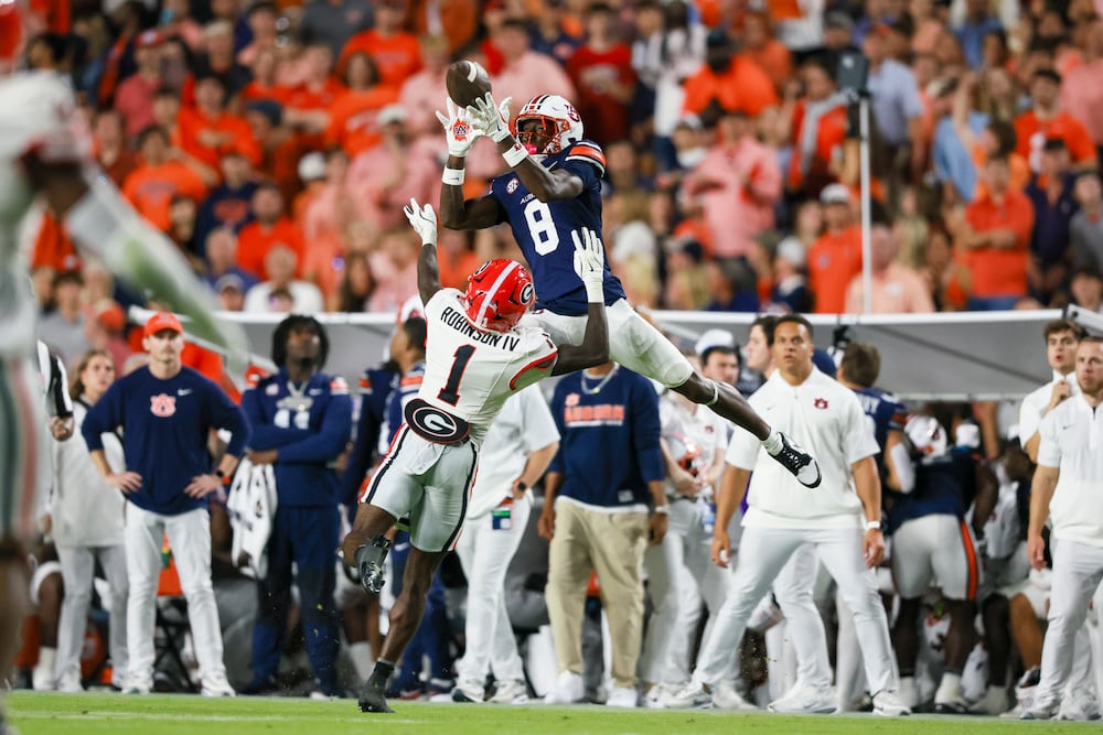 Auburn wide receiver Cam Coleman (top) is unable to make a catch against Georgia defensive back Ellis Robinson IV during the first half at Jordan-Hare Stadium on Saturday, Oct. 11, 2025, in Auburn, Ala. (Jason Getz/AJC)