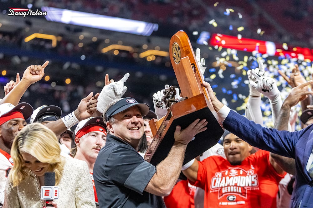 Georgia head coach Kirby Smarts hoists up the trophy after the Bulldogs beat Alabama, 28-7, during their SEC championship game at Mercedes-Benz Stadium on Saturday, Dec. 6, 2025, in Atlanta. (Jeff Sentell/DawgNation)