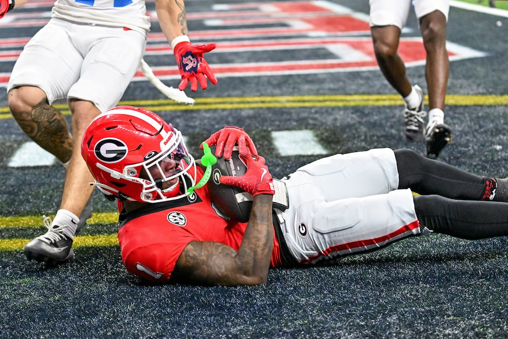 Georgia Bulldogs wide receiver Zachariah Branch (1) makes an 18 yard touchdown pass catch against the Ole Miss Rebels during the fourth quarter of the NCAA College Football Playoff quarterfinal game at the Sugar Bowl in the Caesars Superdome, Thursday, Jan. 1, 2026, in New Orleans. (Hyosub/AJC)